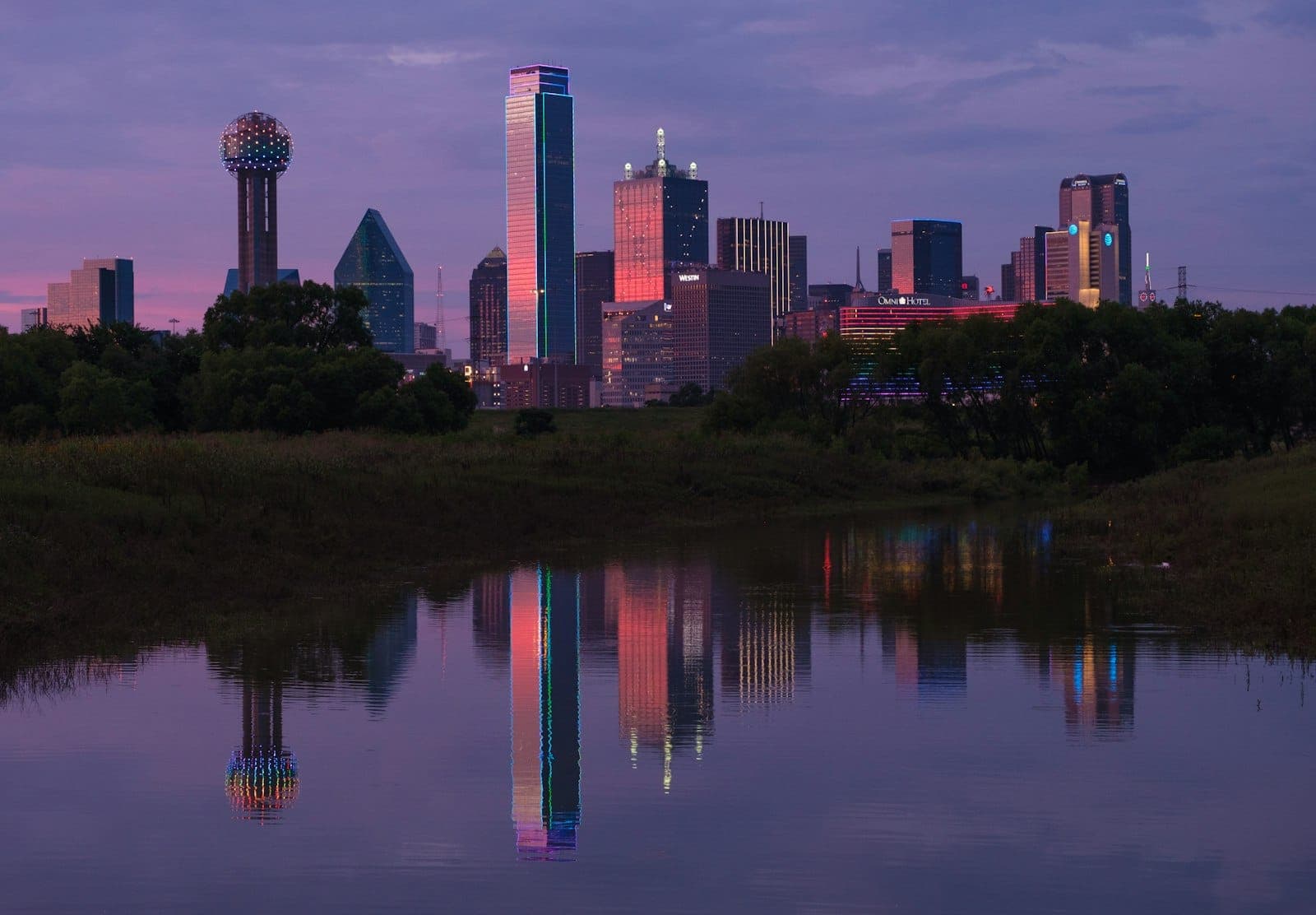 The Dallas skyline reflected in the Trinity River at dusk